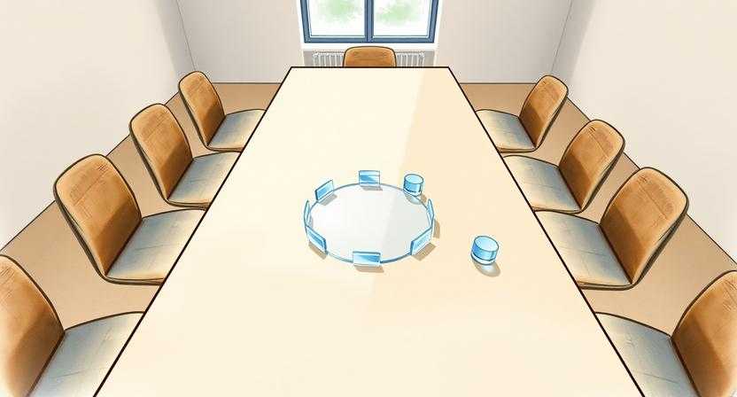 빈 회의 테이블 위에 투명한 유리 조각들이 원형으로 놓여 있다